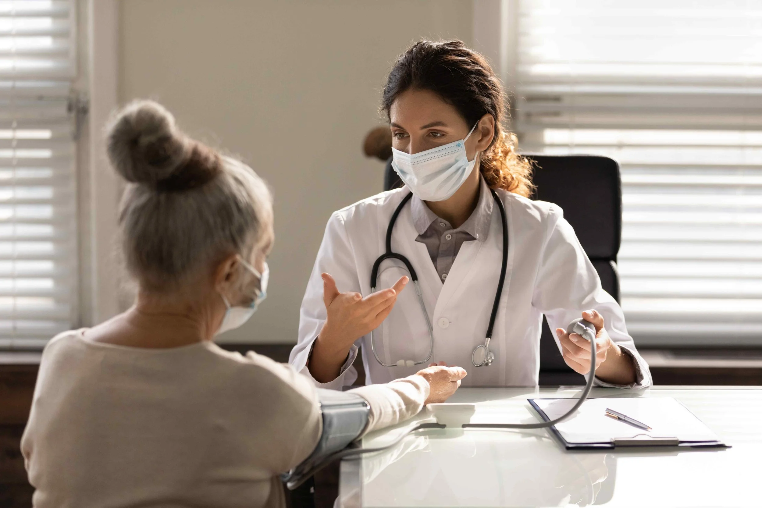 Female doctor taking a patient’s blood pressure during a cardiology consultation, WE Cardiology, London