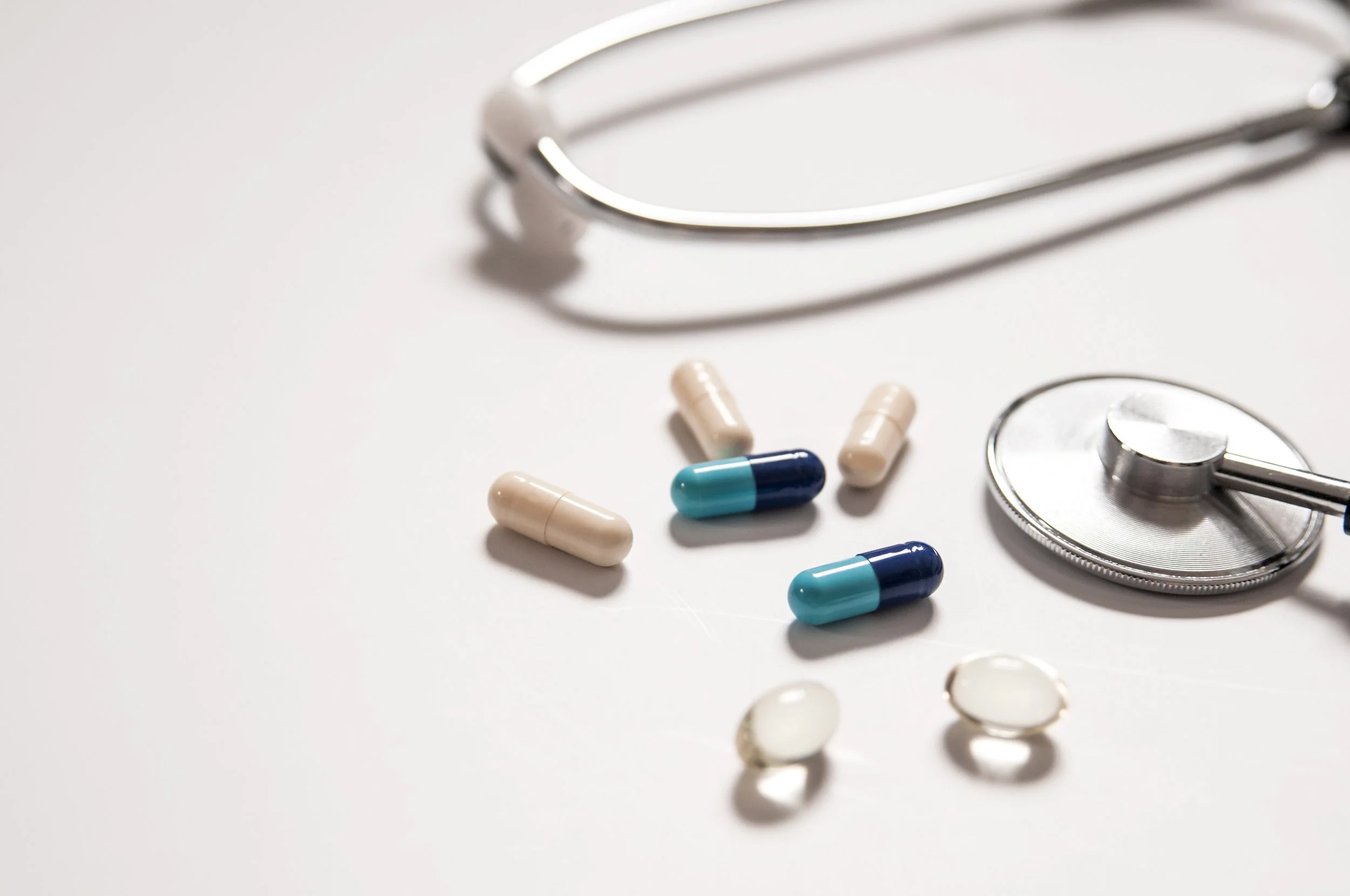 Stethoscope and medication on a white table representing private cardiac care and treatment at WE Cardiology, London