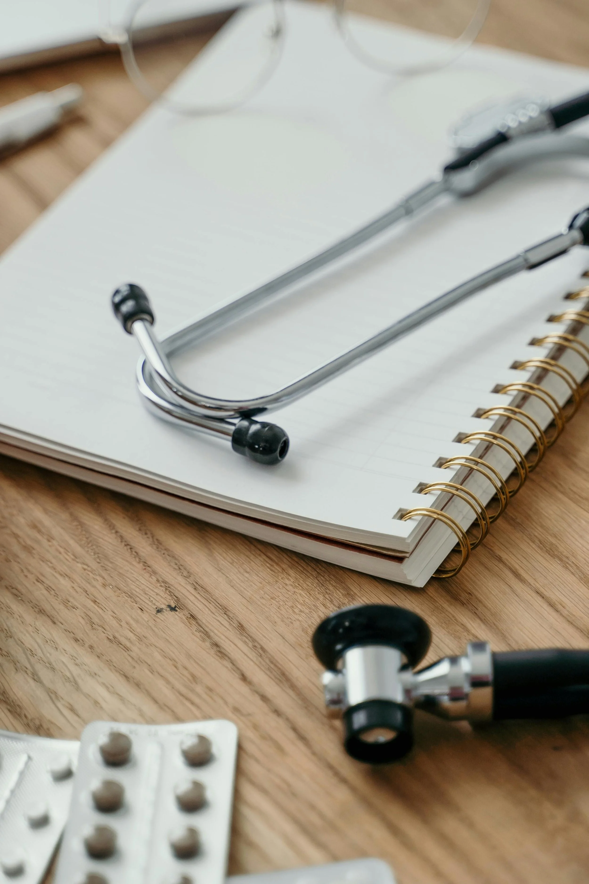 Stethoscope and notebook on a desk at a private cardiology consultation, WE Cardiology London