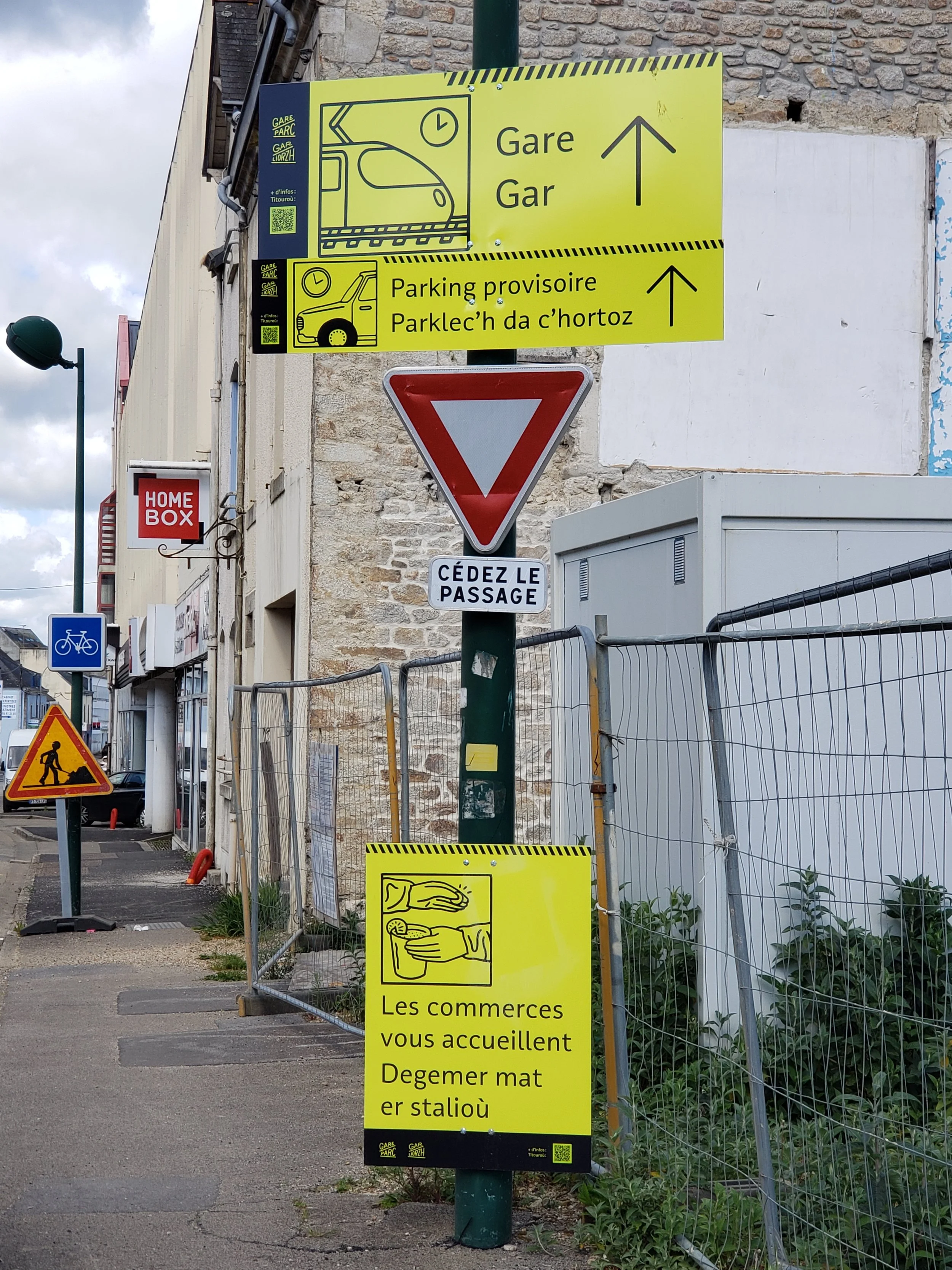 A bilingual construction zone sign in Quimper, France, written in both French and the ancient Breton language, reflecting the strong cultural identity and linguistic heritage of the Brittany region.