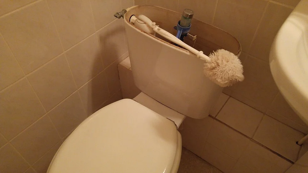 A improvised plumbing fix at the Hôtel Mère Michelet in Confolens, France - proof that a little travel ingenuity goes a long way.