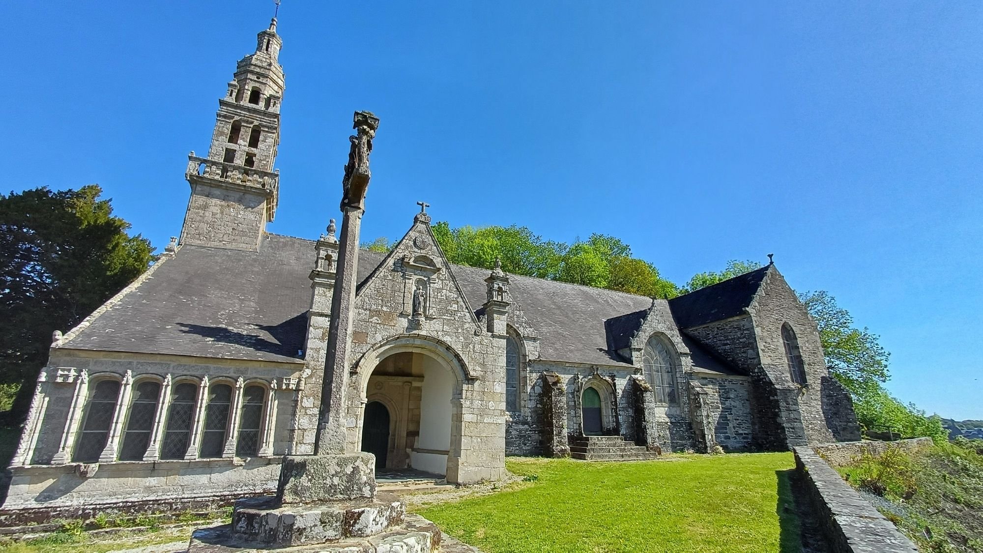 Stone facade of the dual-purpose church and chapel, the Chapelle Notre-Dame in Châteaulin, Brittany, France.