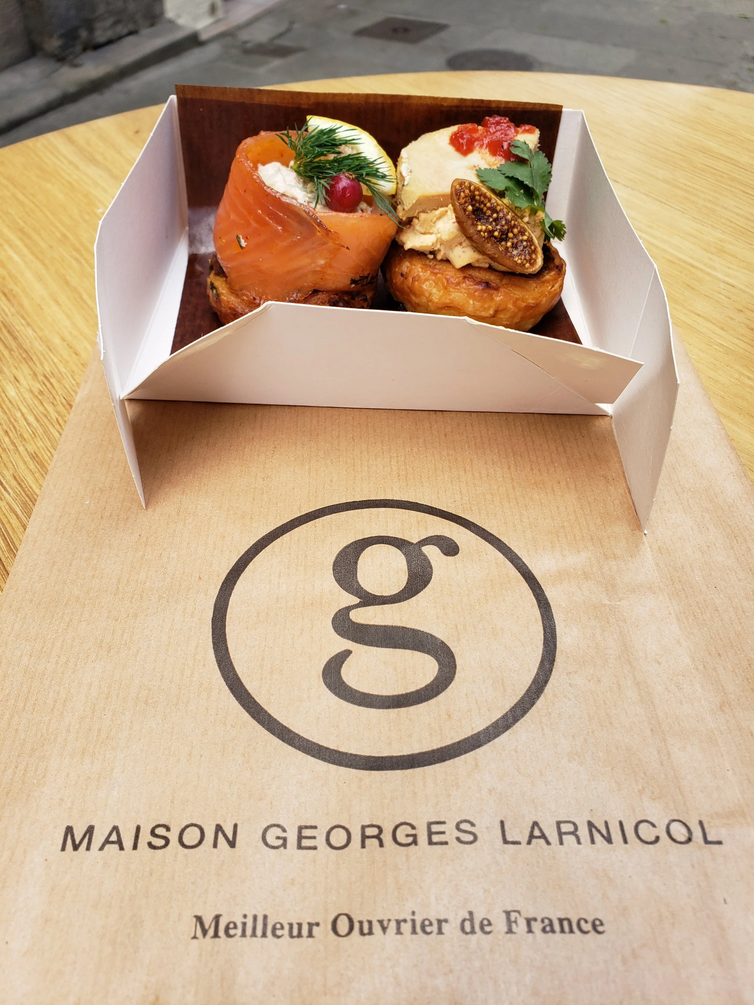 Traditional kouignettes from Maison Georges Larnicol in Quimper, France, miniature versions of the famous Breton kouign-amann pastry, topped with smoked salmon and foie gras in both classic and savory styles.