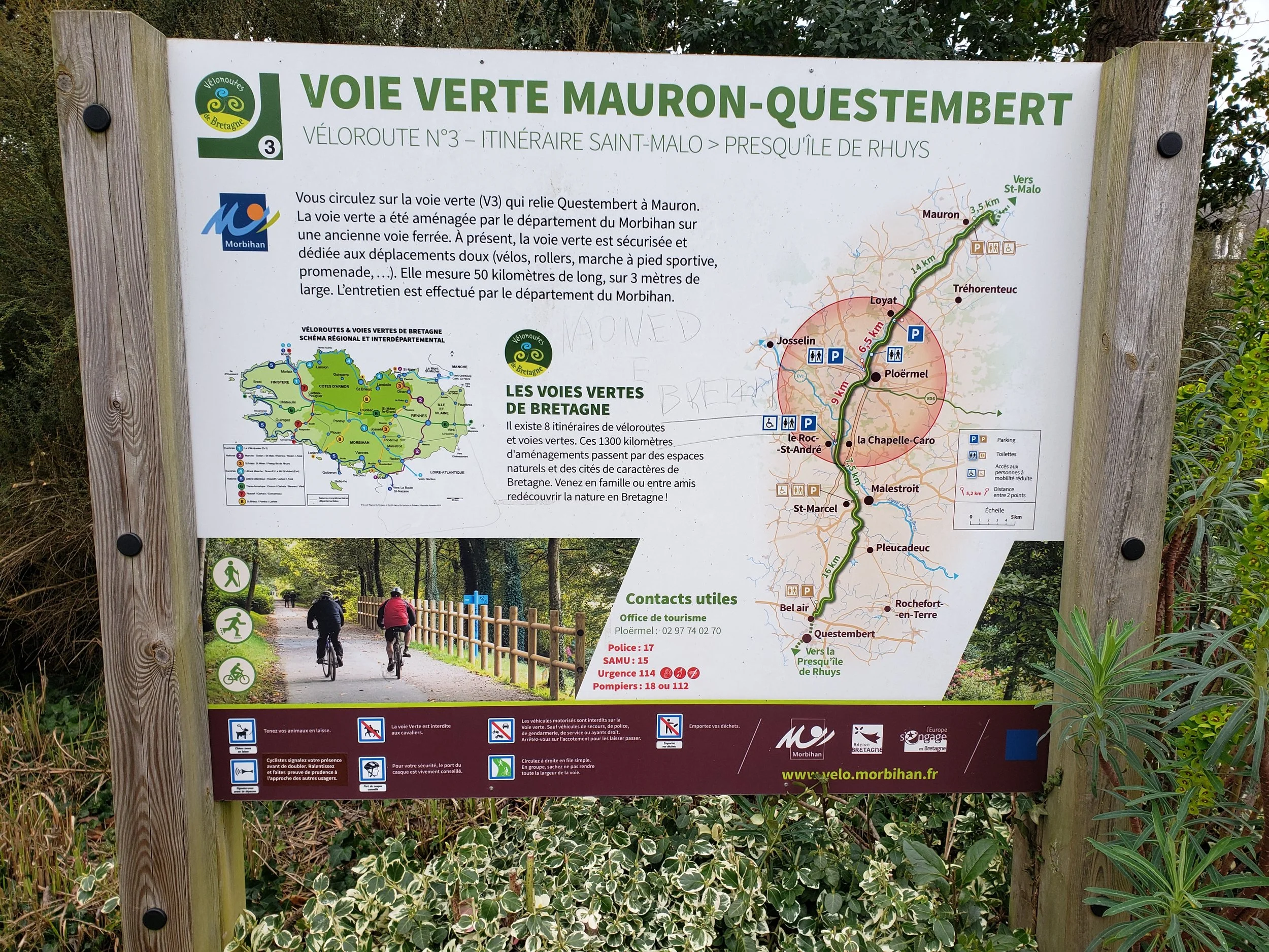 The wide, well-maintained asphalt surface of the Voie Verte Mauron-Questembert cycling and walking trail near Ploërmel, France, part of a network of over 800 miles of similar greenway trails across Brittany.
