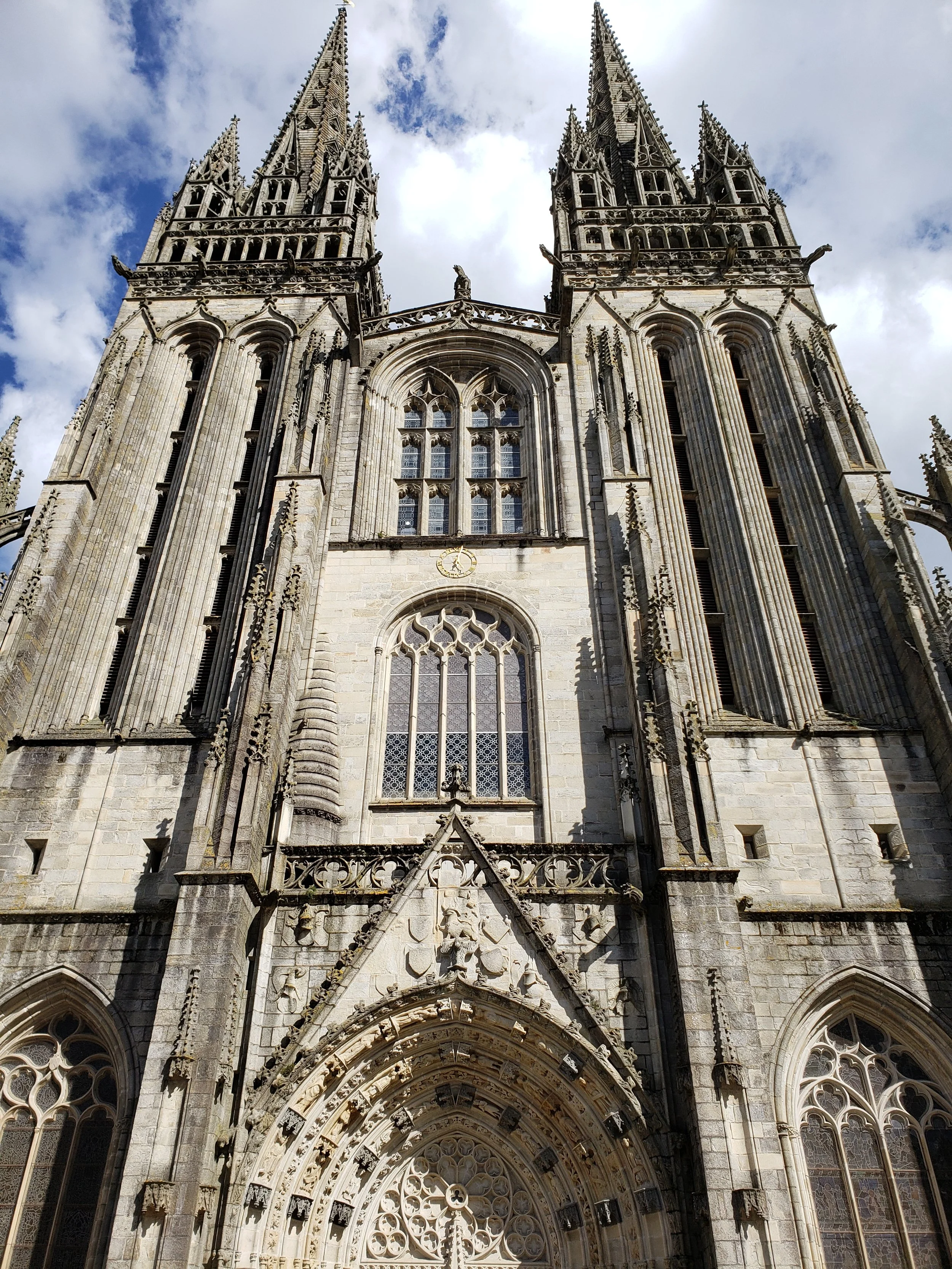 The imposing gothic western façade of the Saint Corentin Cathedral in Quimper, France, a national monument and seat of the Diocese of Quimper and Léon, the first part of which was constructed in 1239.