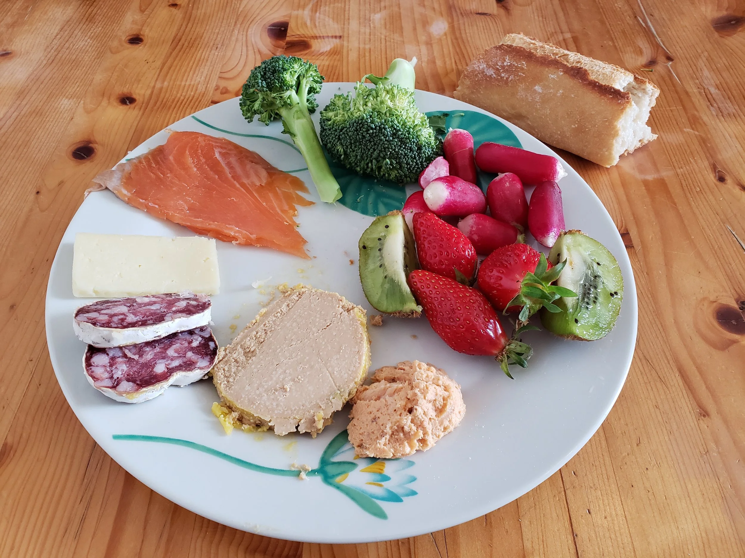 Colorful lunch plate of fresh fruit, vegetables, meat, cheese and seafood in Bénodet, Brittany, France