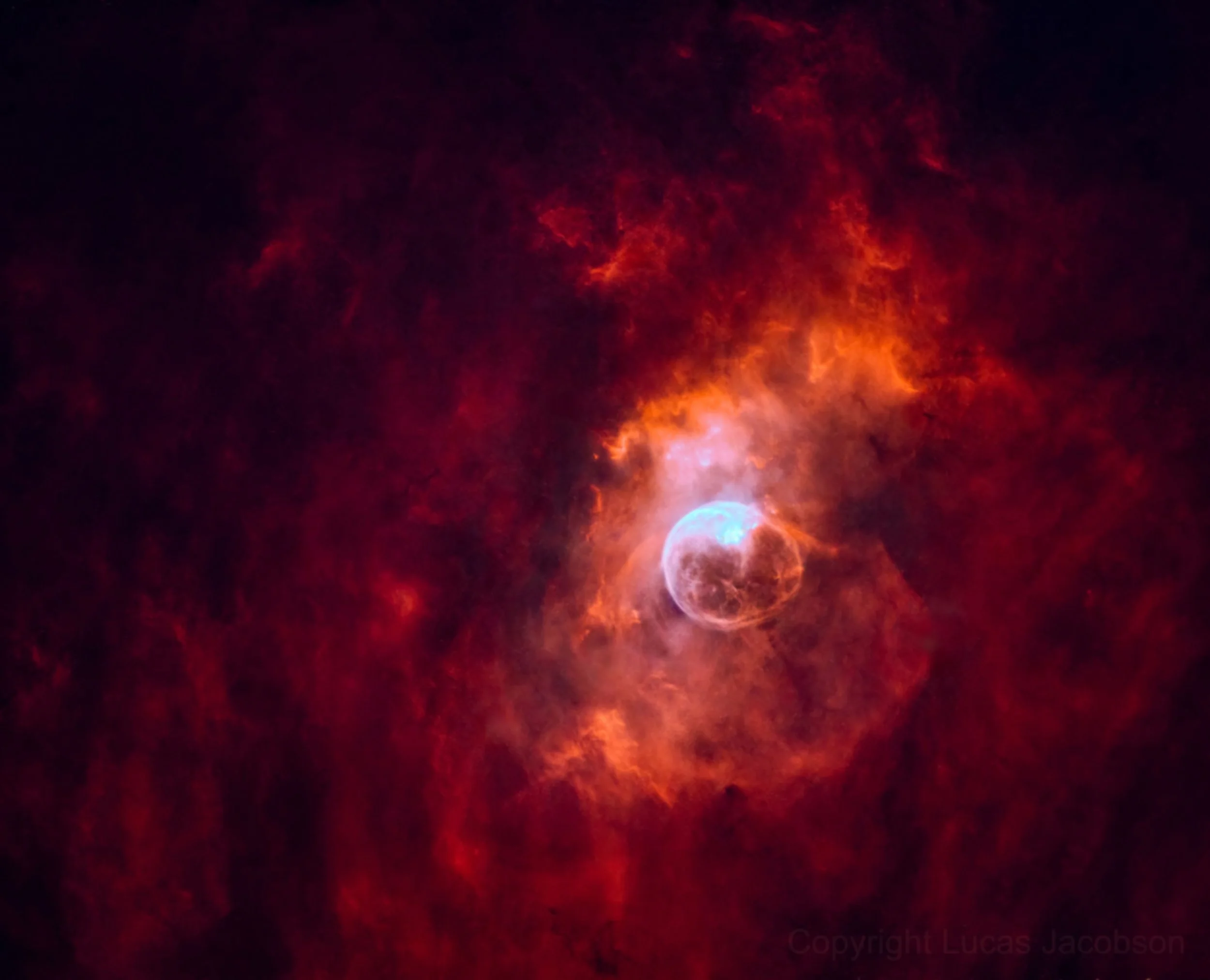 Bright stars and glowing clouds of deep red and orange nebulae in outer space.