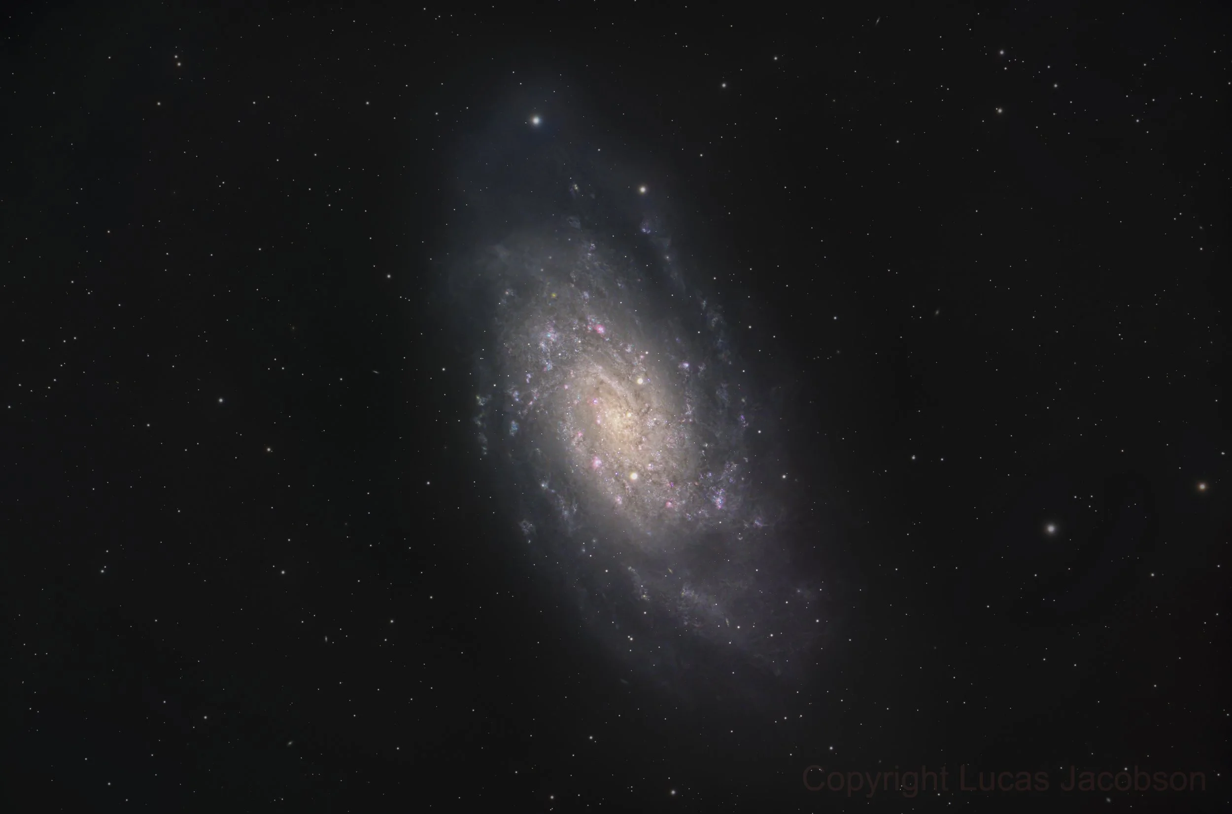 A view of the galaxy with stars, dust, and cosmic formations against a black backdrop.