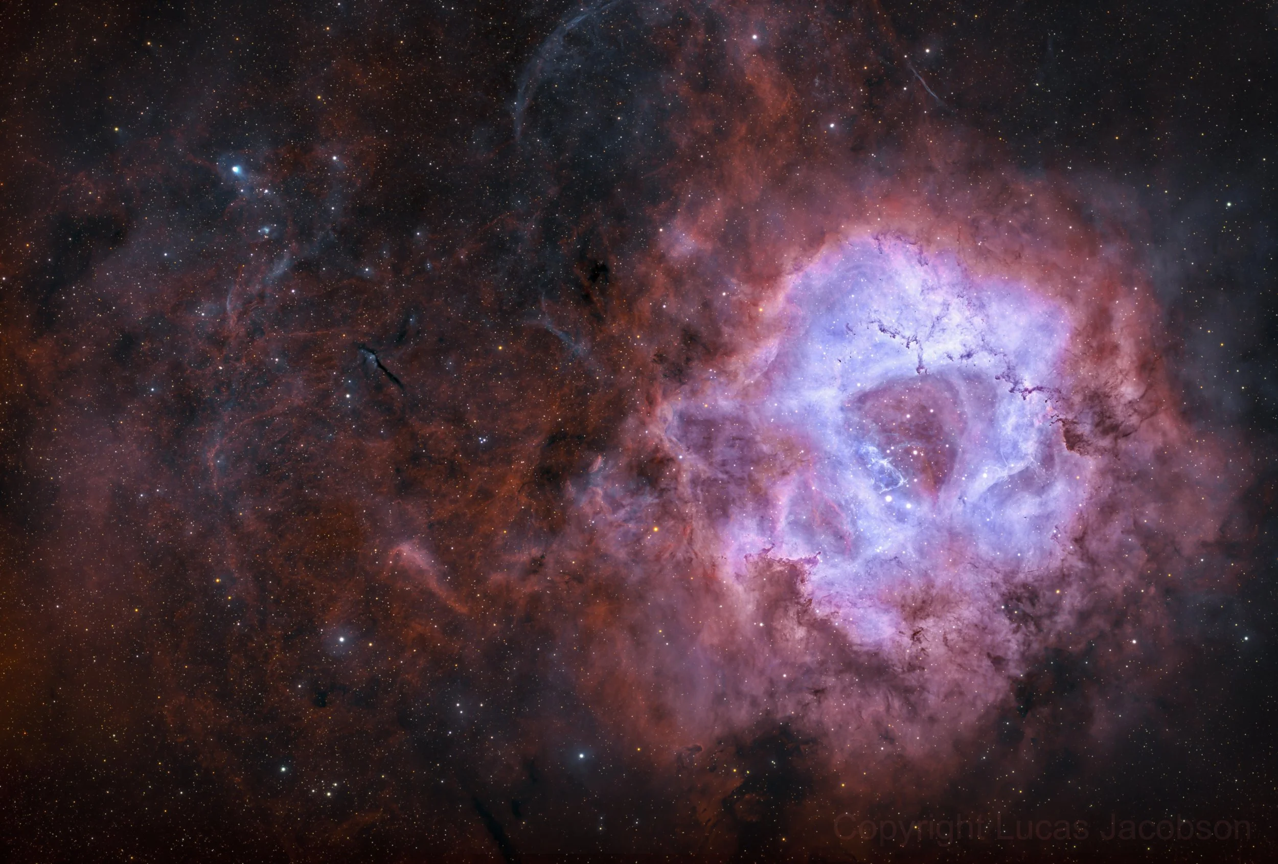 A colorful image of a galaxy or nebula in deep space, featuring bright stars, clouds of gas and dust, and vibrant hues of pink, purple, and blue.