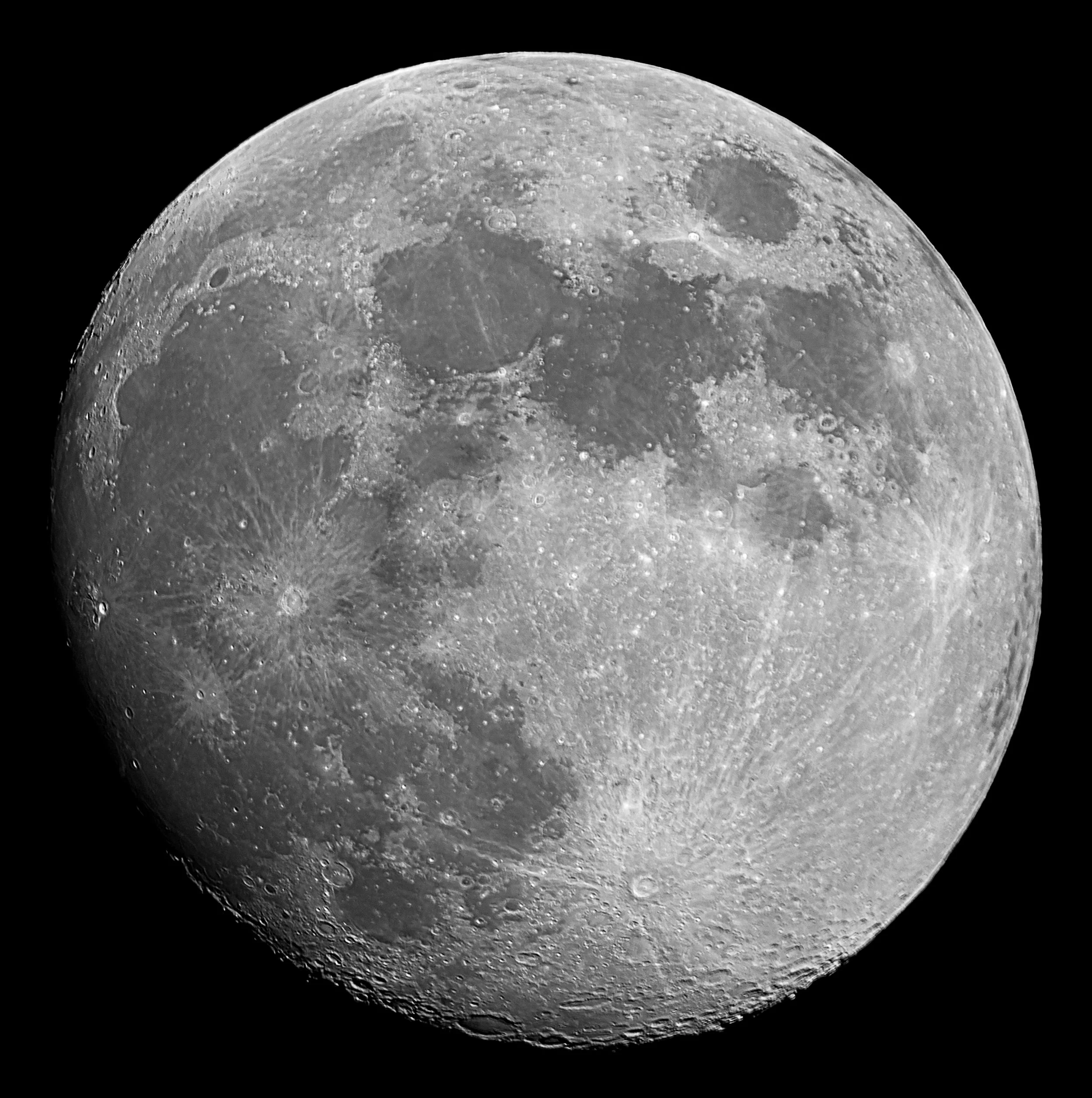 Close-up image of the moon's cratered surface against a black background.