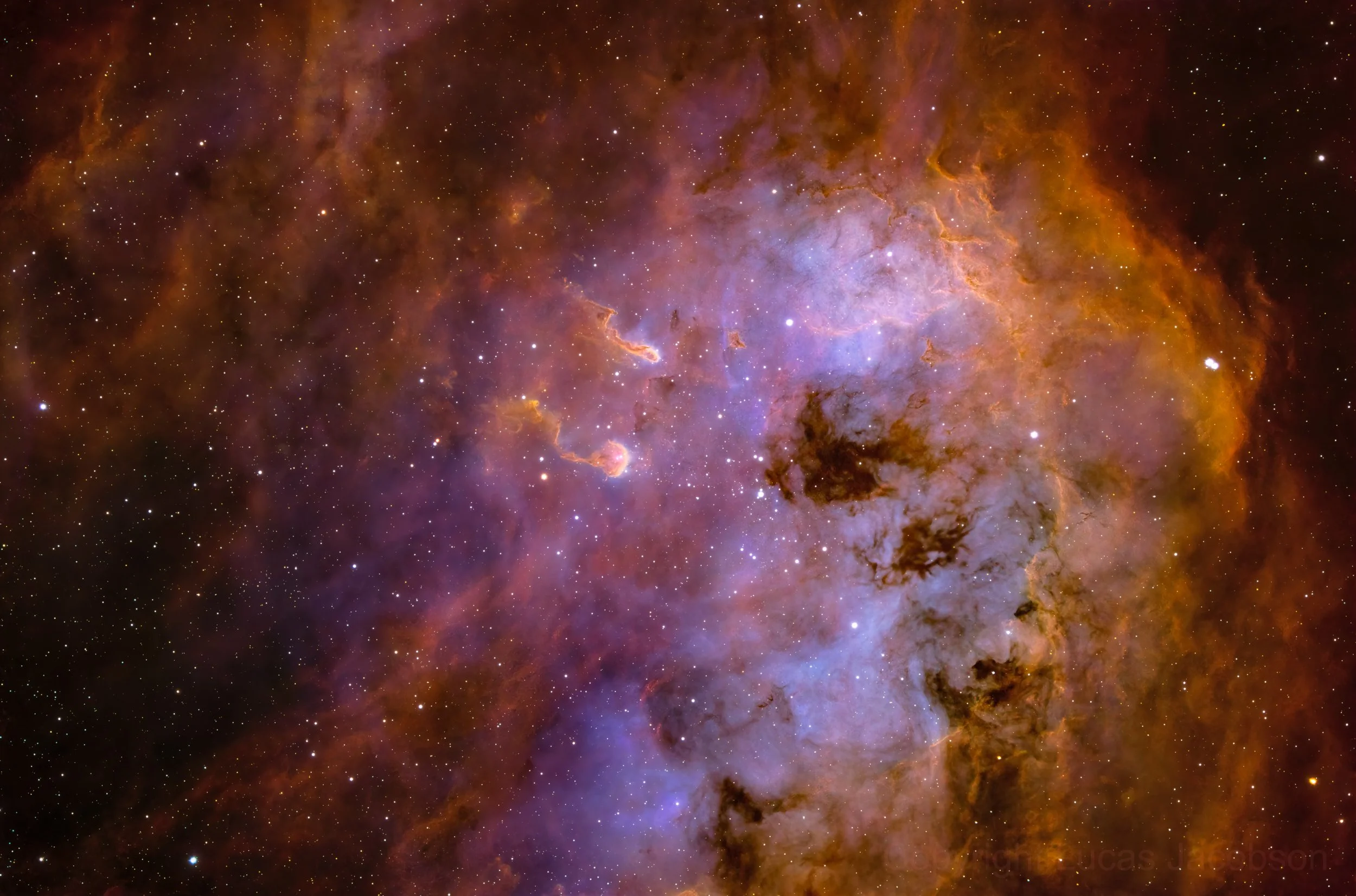 Colorful image of a nebula in outer space with stars scattered throughout