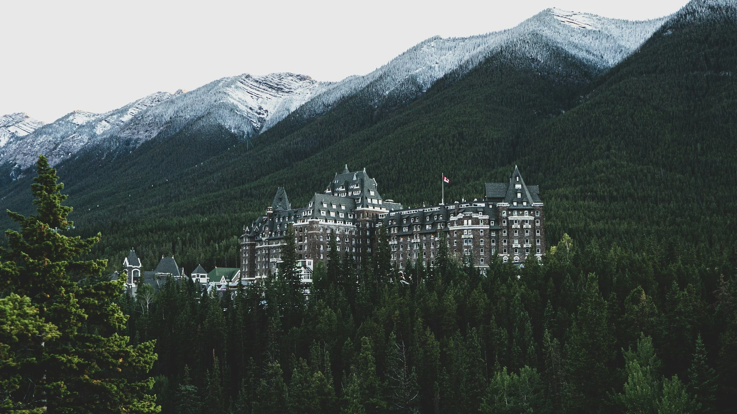 Fairmont Banff Springs surrounded by forest and mountains in Banff, Canada