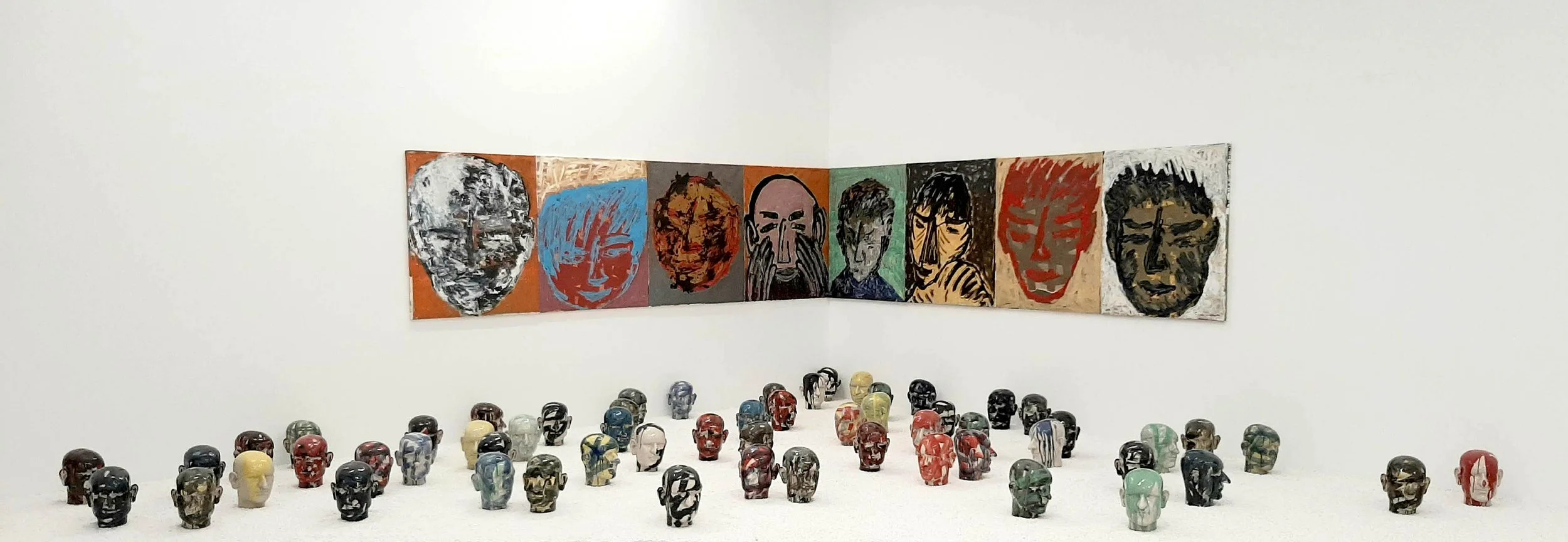 People, 2019 coloured ceramic heads and paintings on canvas , variable