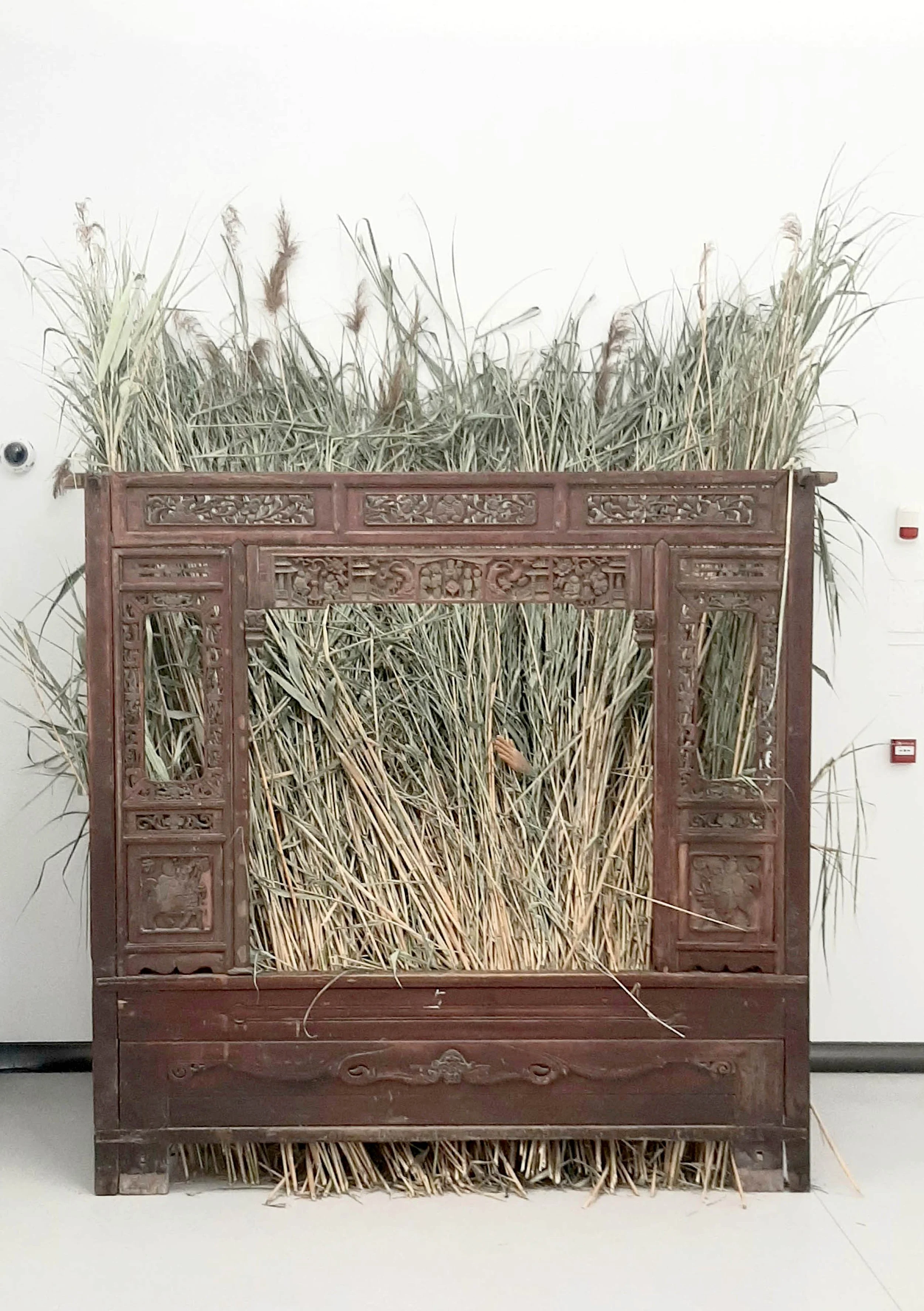 The River Yang Cheng, 2023 an old bed, reeds and a hand object from synthetic resin 300cmx200cm160cm