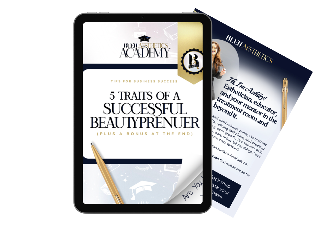Digital tablet displaying an eBook titled '5 Traits of a Successful Beautypreneur' from Bleu Aesthetics Academy, with a gold pen resting on the cover, and part of a promotional flyer visible behind the tablet.
