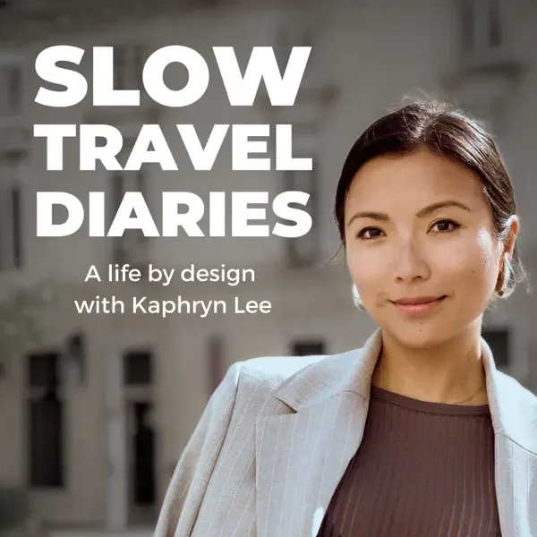 Book cover titled "Slow Travel Diaries: A Life by Design with Khapryn Lee," featuring a portrait of Khapryn Lee wearing a blazer and smiling, with a blurred cityscape background.