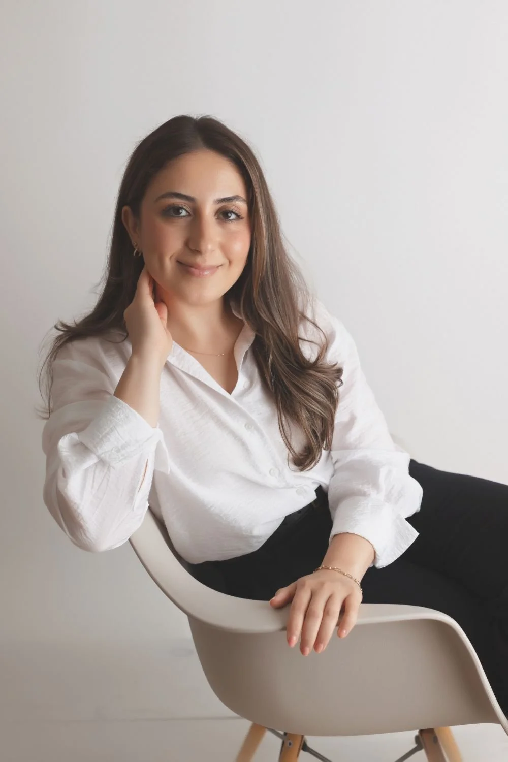 Full body shot of Shabnam sitting on a chair