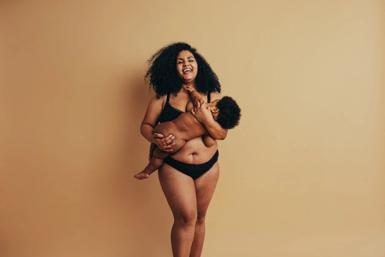 woman holding baby smiling