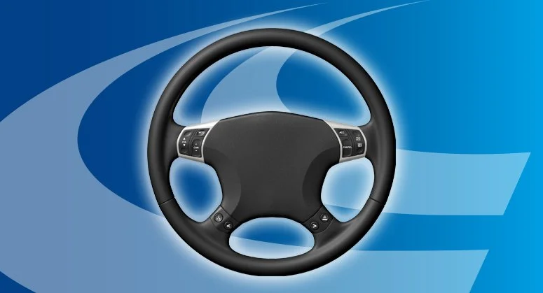 A black car steering wheel with control buttons on a digital blue background.