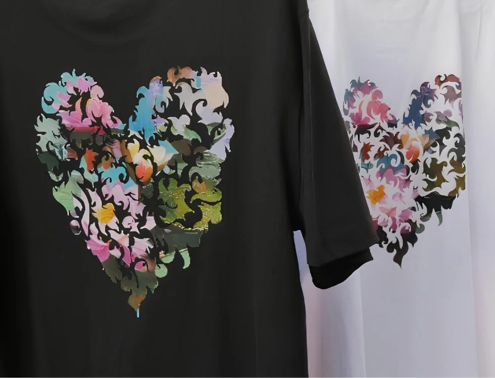 Deux T-shirts graphique en coton lourd, un noir et un blanc, suspendus à une corde à linge. On voit le design cœur avec inspiration tableau Monet face arrière sur chaque t-shirt. Marque de streetwear créée à Albi