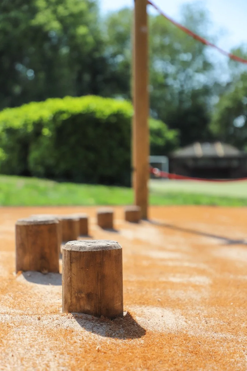 Kids Playground with natural surfacing and wooden trim trail