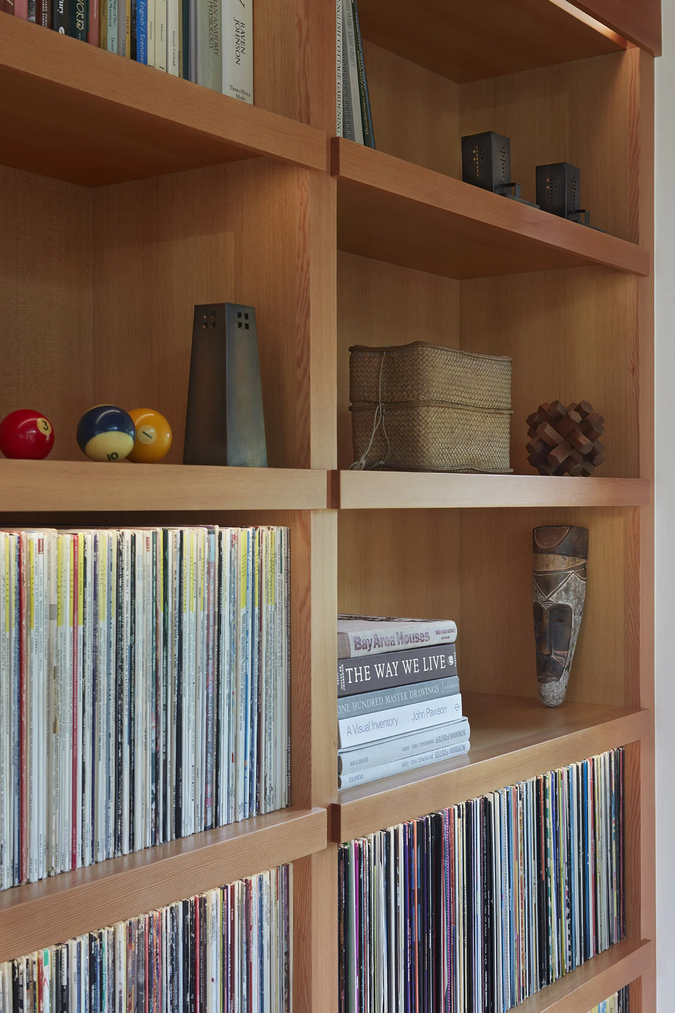  custom built shelves with integrated lighting and shoulder detail house the homeowner's vinyl collection.&nbsp; 