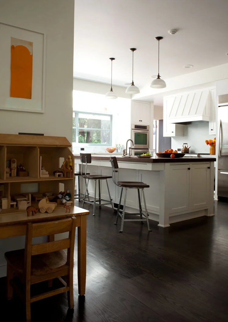 The kitchen features sustainably harvested wood and marble. The existing cabinetry was preserved and refreshed wherever possible, to minimize waste.  Photography: Leslie Williamson (Copy)
