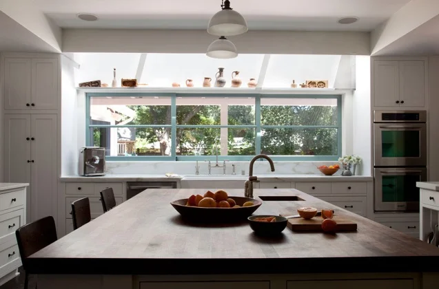 The kitchen views open onto the pool. The windows slide open to an outdoor serving counter.  Photography: Leslie Williamson (Copy)