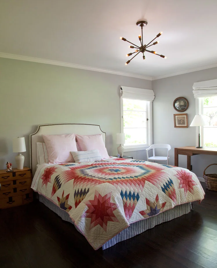 This eclectic bedroom displays the quilts made by relatives. Photography: Leslie Williamson (Copy)