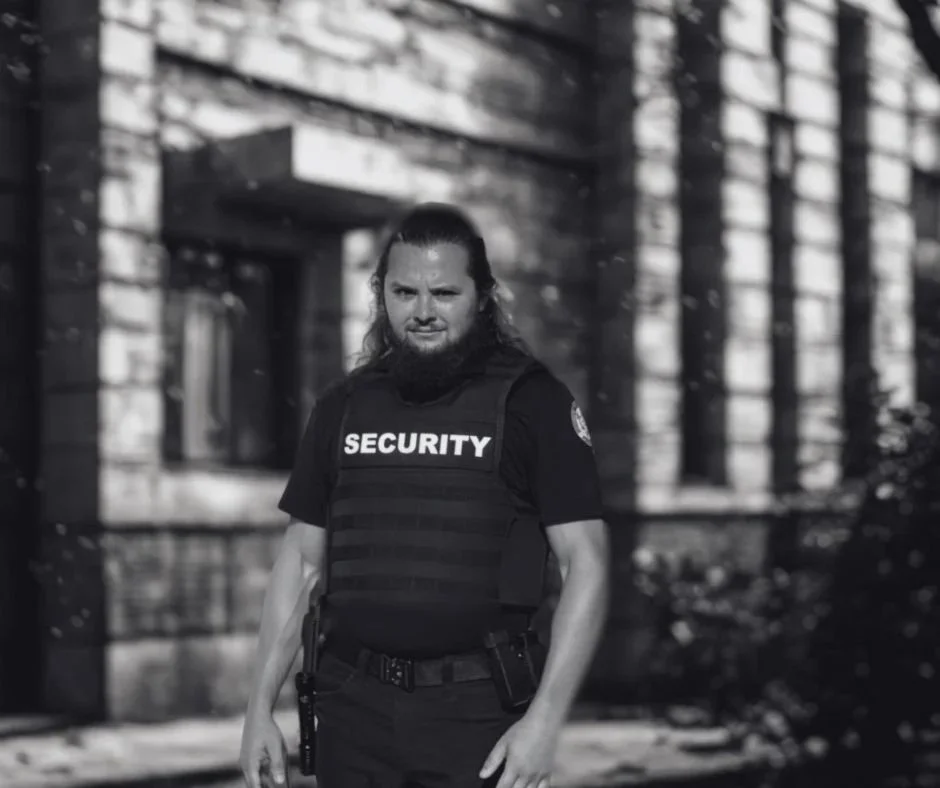 Armed security officer assisting staff and visitors while supporting daily operations.