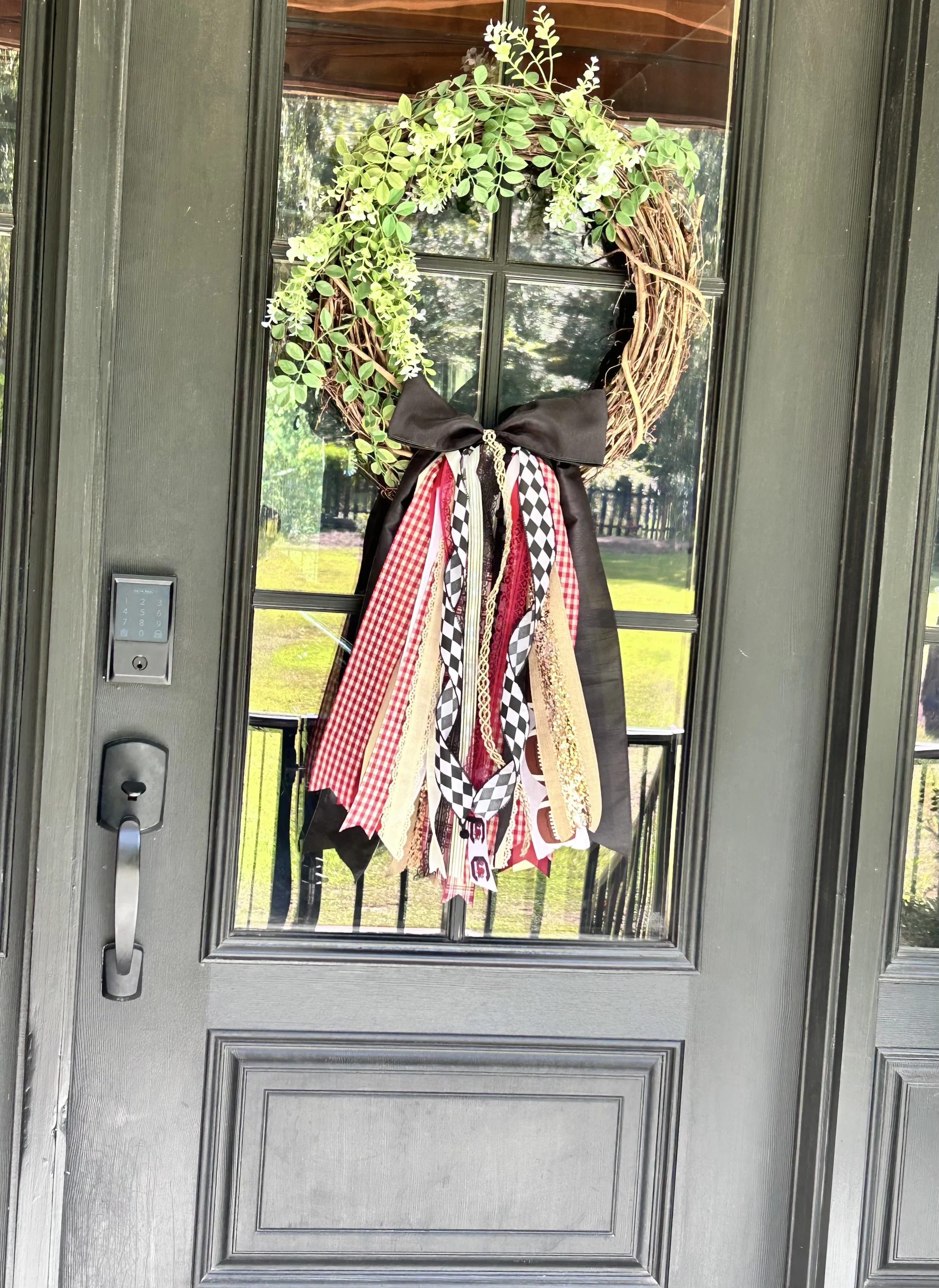 Handcrafted Southern Cascade garnet and black bow with long layered ribbon tails