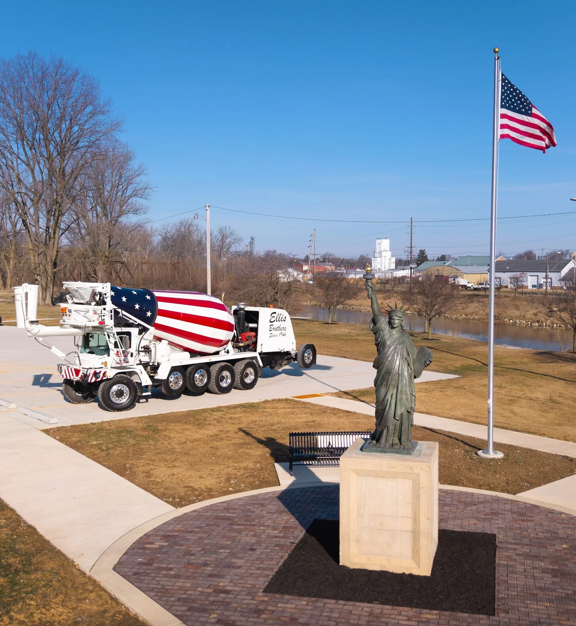 Ellis Brothers cement truck in US Flag themed wrap near Statue of Liberty