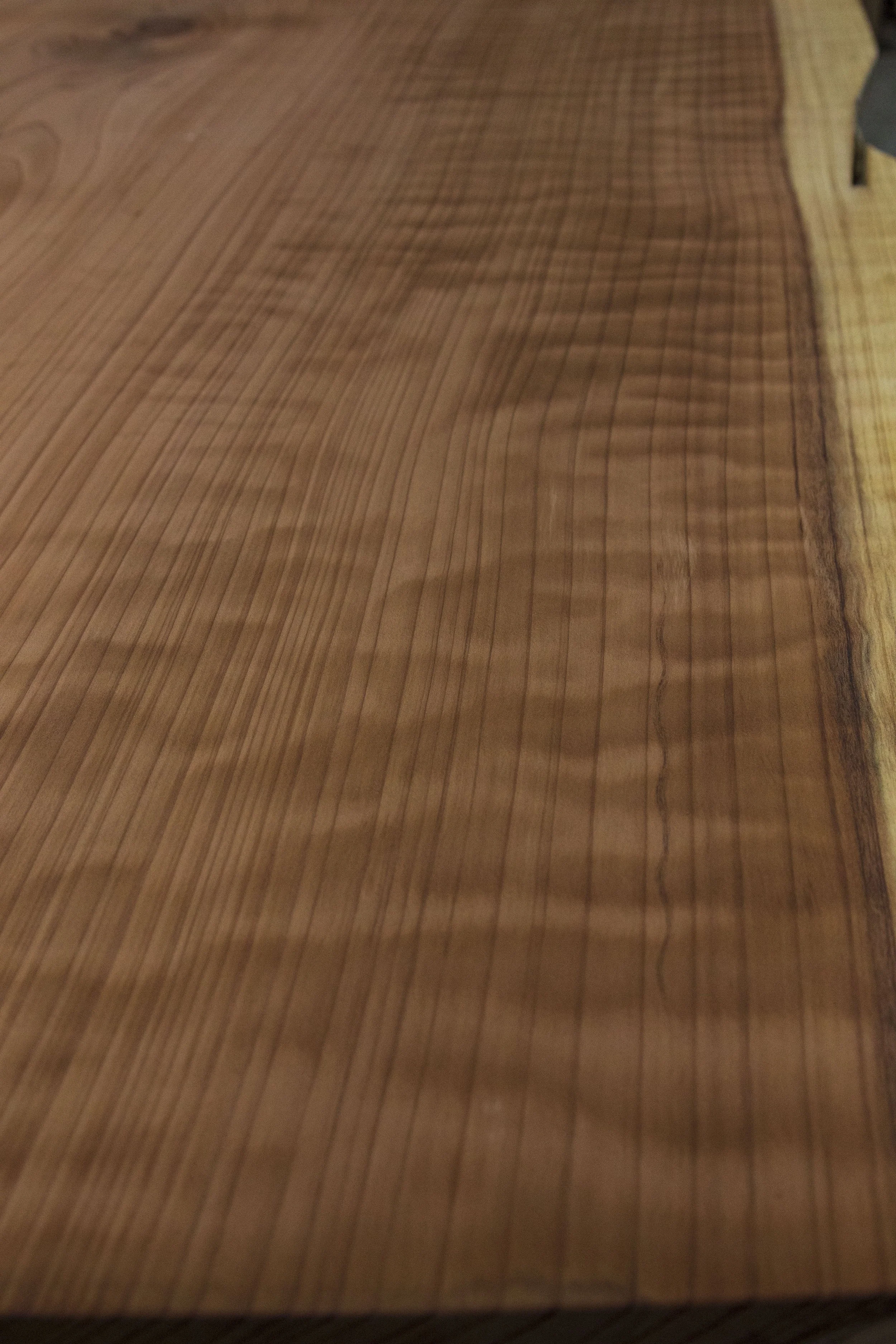 Wavy grain detail in surfaced redwood slab