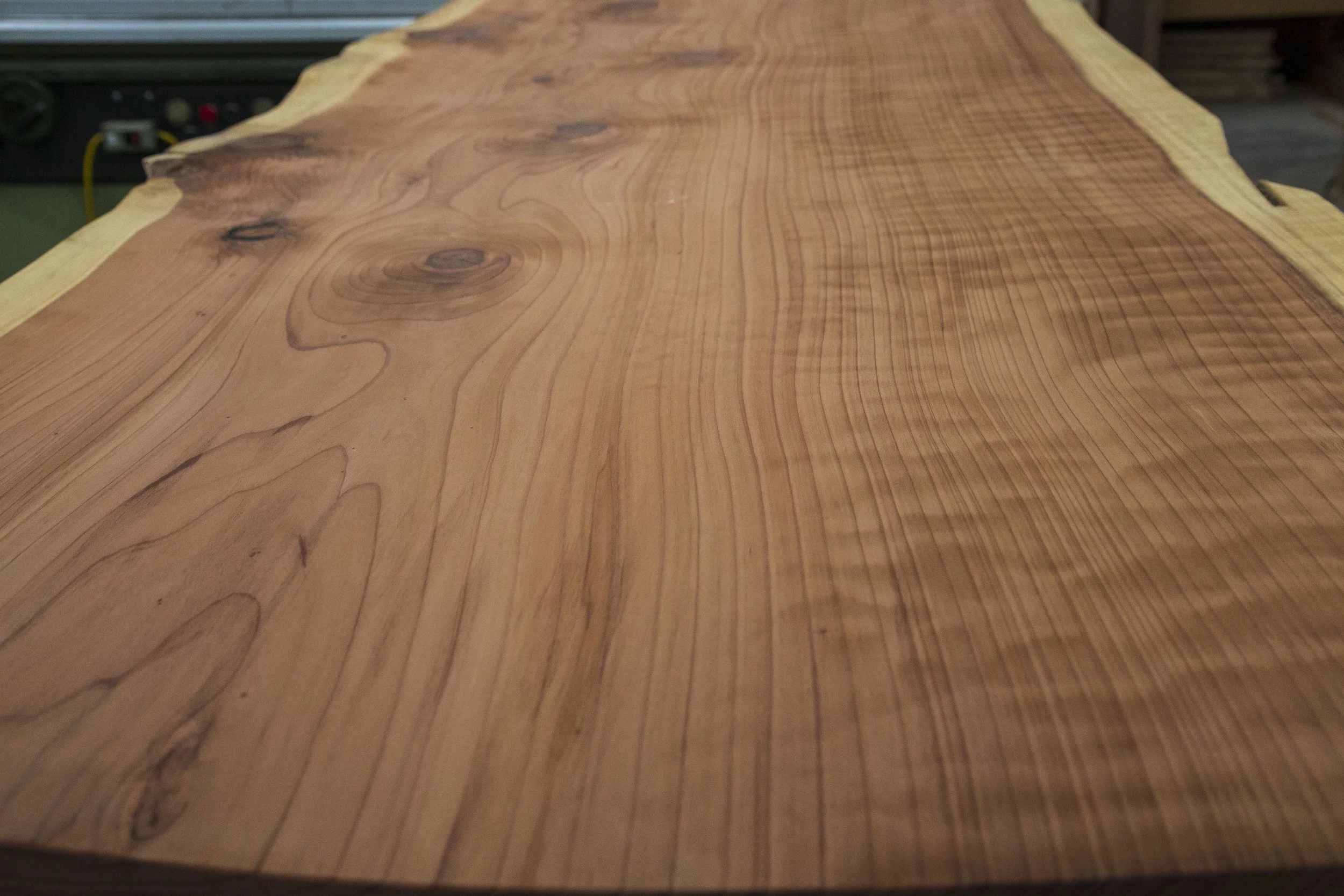 Wavy grain patterns in surfaced redwood slab