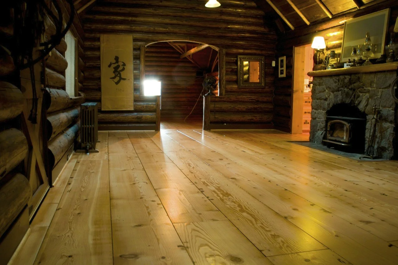 Wide-plank flooring in log cabin