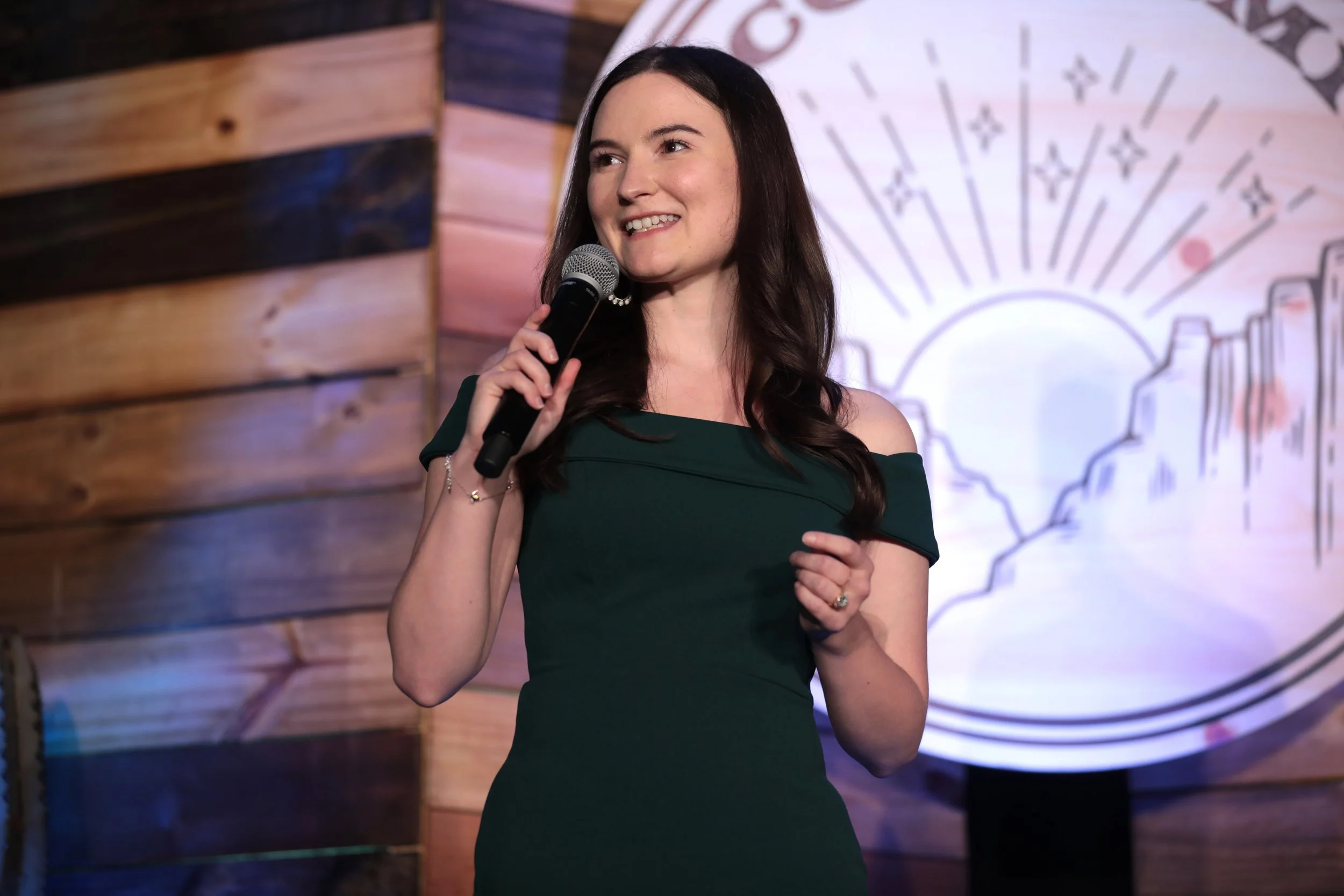 Danielle Franz on the ACC Summit stage, in a green dress.