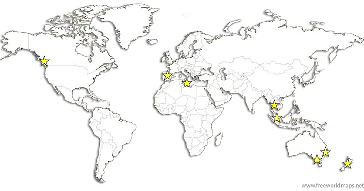 World map with coastline outlines, black background, Europe, Asia, and Australia highlighted in blue with yellow stars marking specific locations. In North America, a star is off the west coast, in Europe near the UK, and in Asia around Japan. Several stars are in Australia and Southeast Asia.