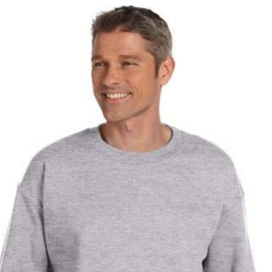 A man with short gray hair wearing a light gray sweater, smiling and looking to his left, against a plain white background.