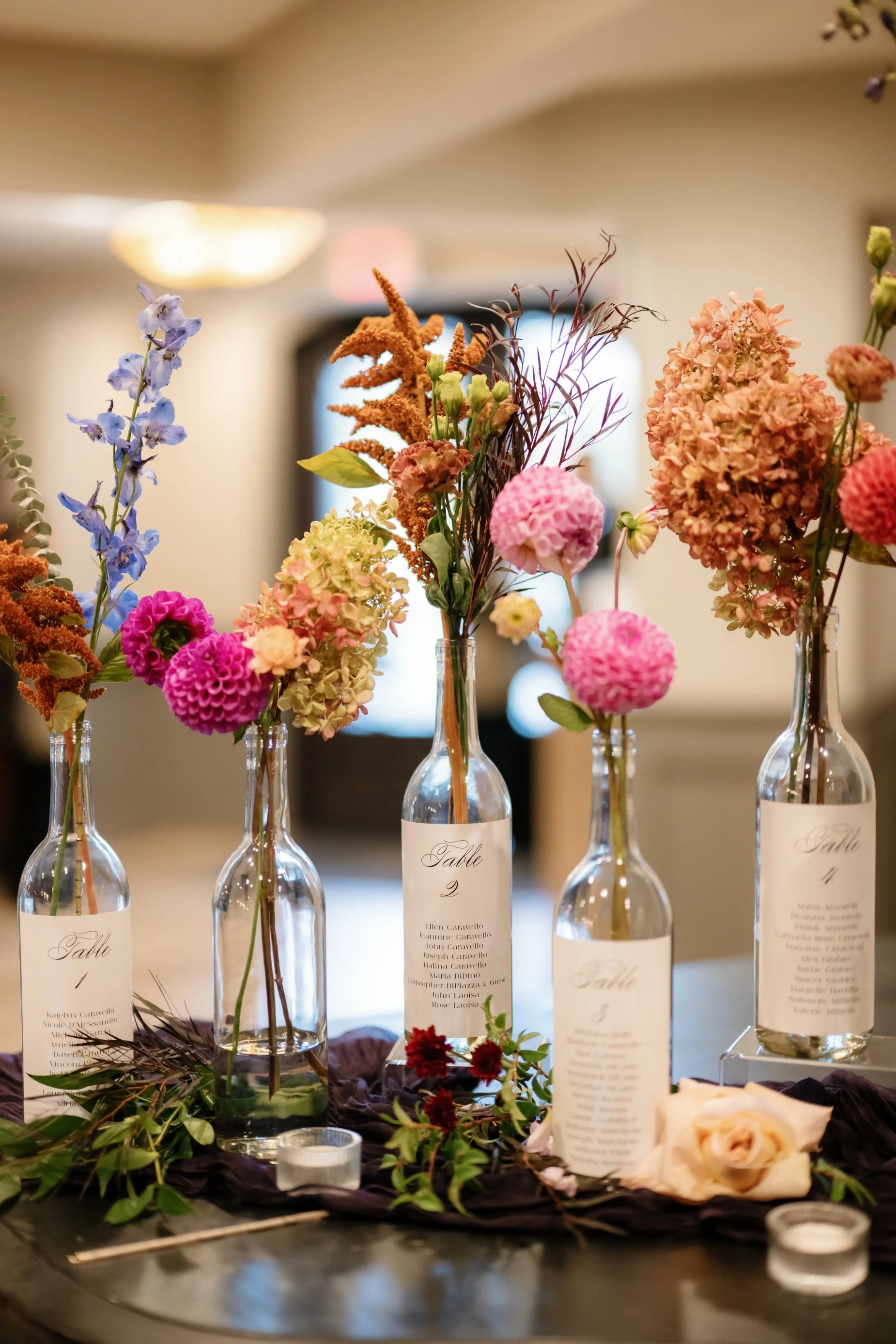 wedding florals in wine bottles decor.jpg