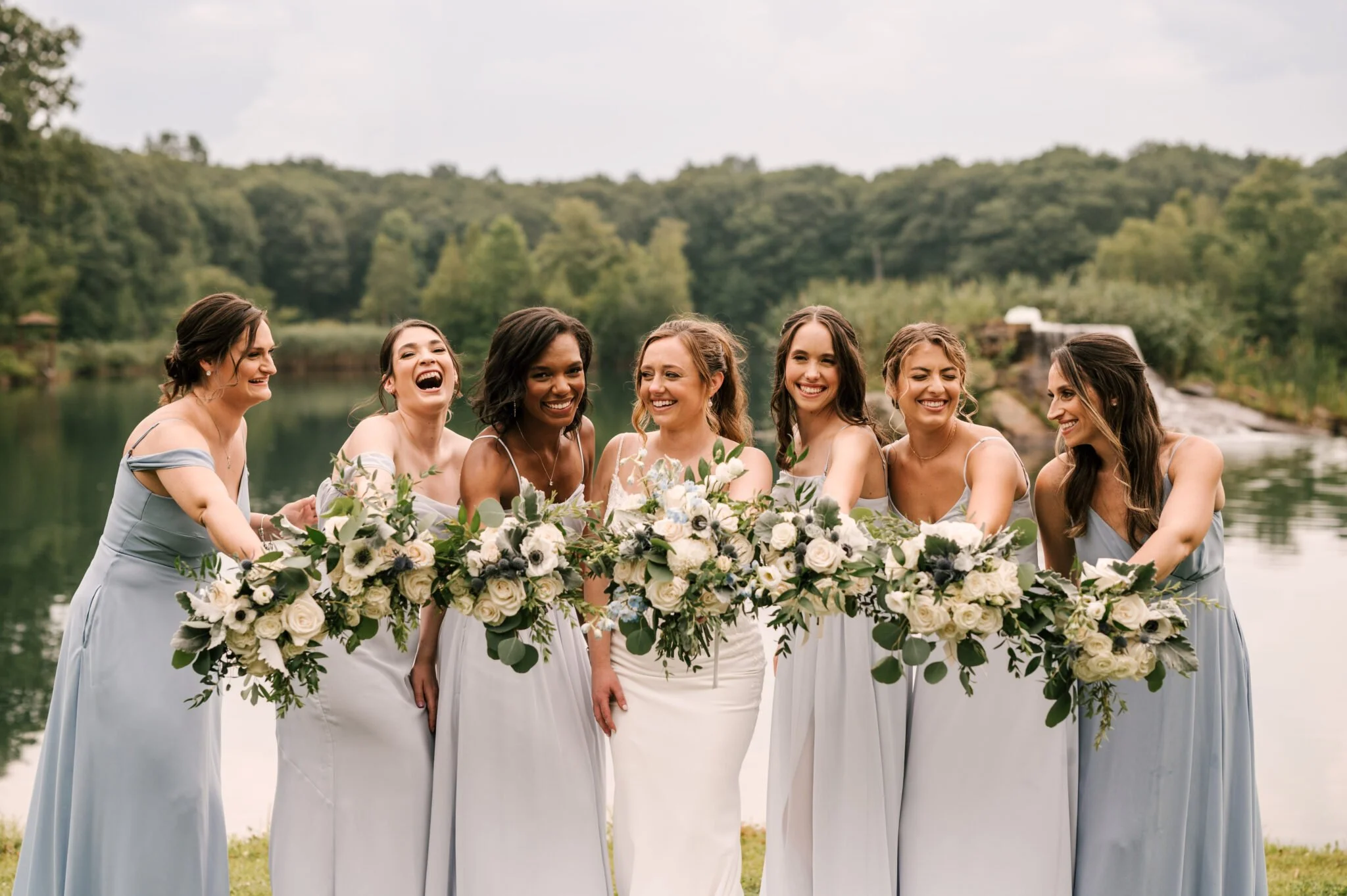 bridesmaids holding their bouquet at a lakeside nj wedding venue.jpg