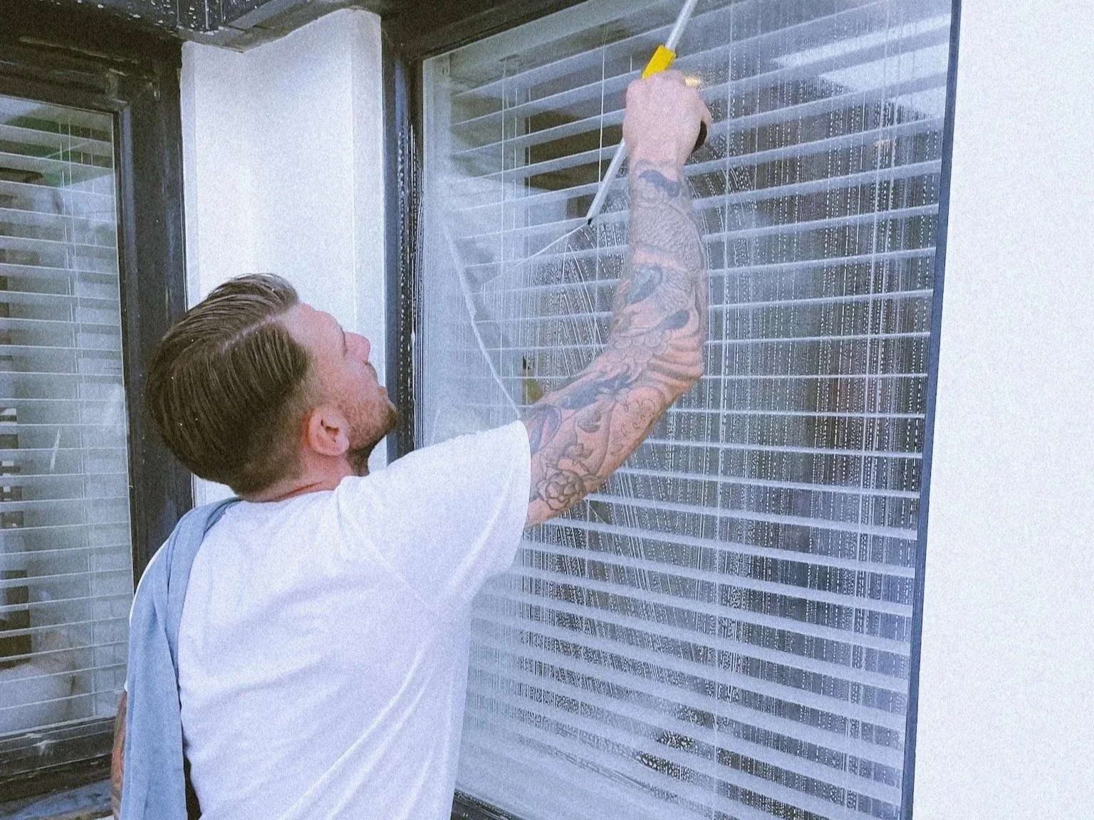 Traditional window cleaner cleaning windows in Hailsham