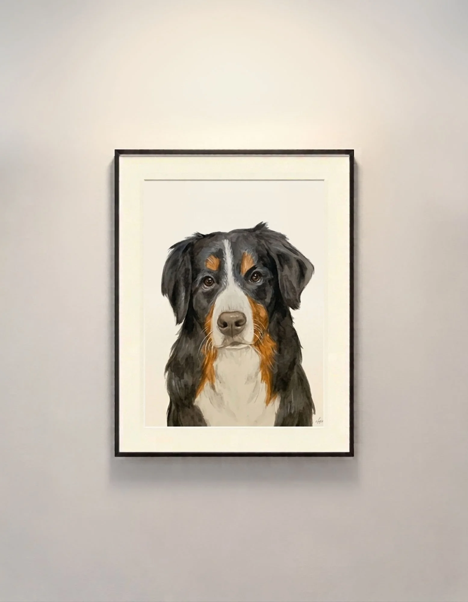 A framed watercolor and gouache realistic painting of a dog with black, brown, and white fur, looking straight ahead, hanging on a white gallery wall.