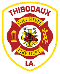Thibodaux Volunteer Fire Department badge with red and yellow colors, featuring firefighting symbols, established date 1874, and location Louisiana.