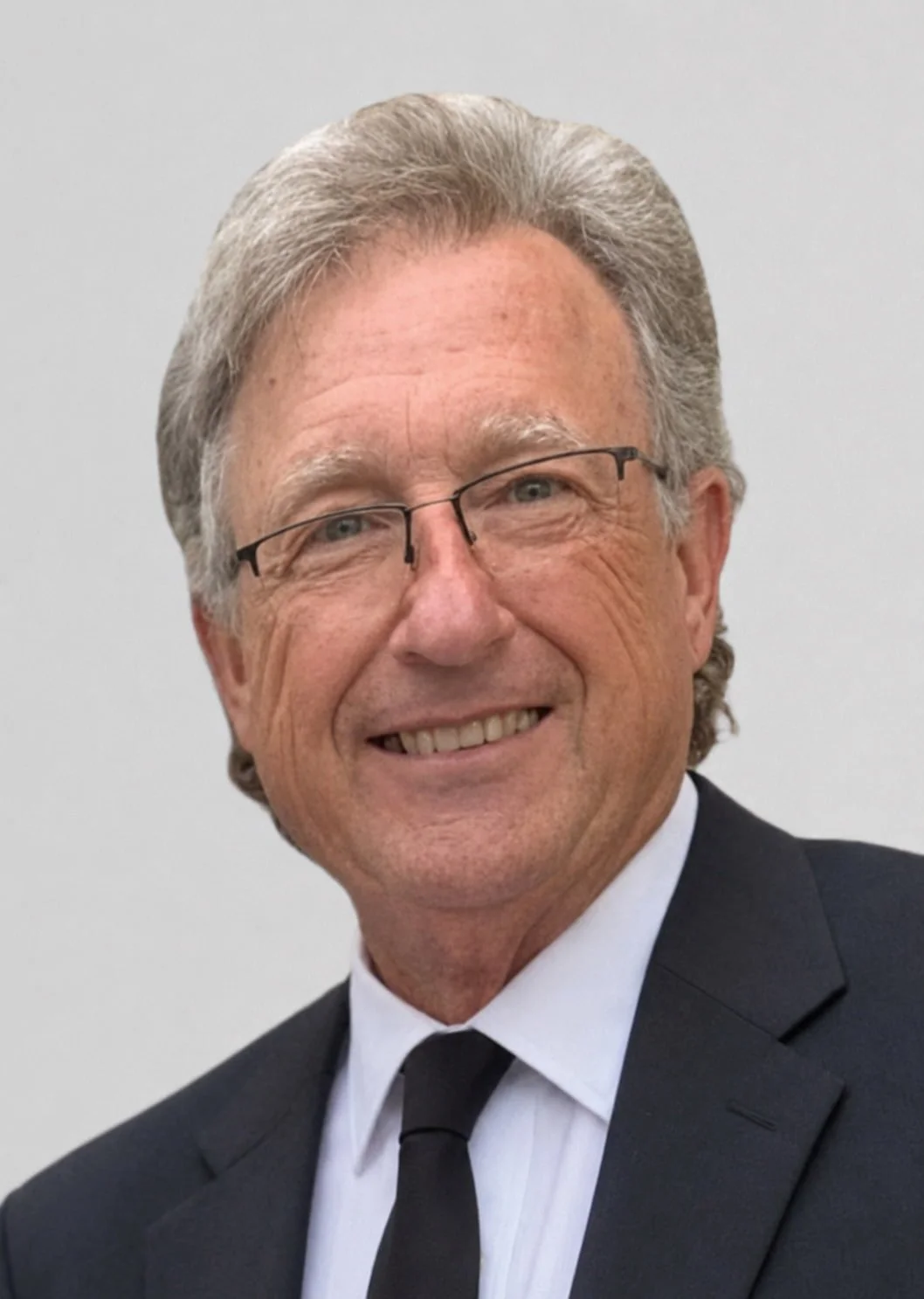 Robert Theriot wearing a black suit, white shirt, and black tie.