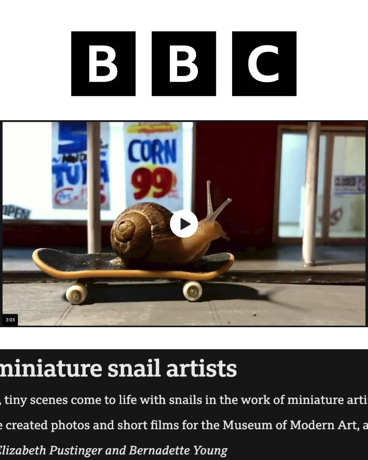 A miniature snail with a shell, positioned on a tiny skateboard, with a background of a store window with signs, including one that reads 'CORN 99'.