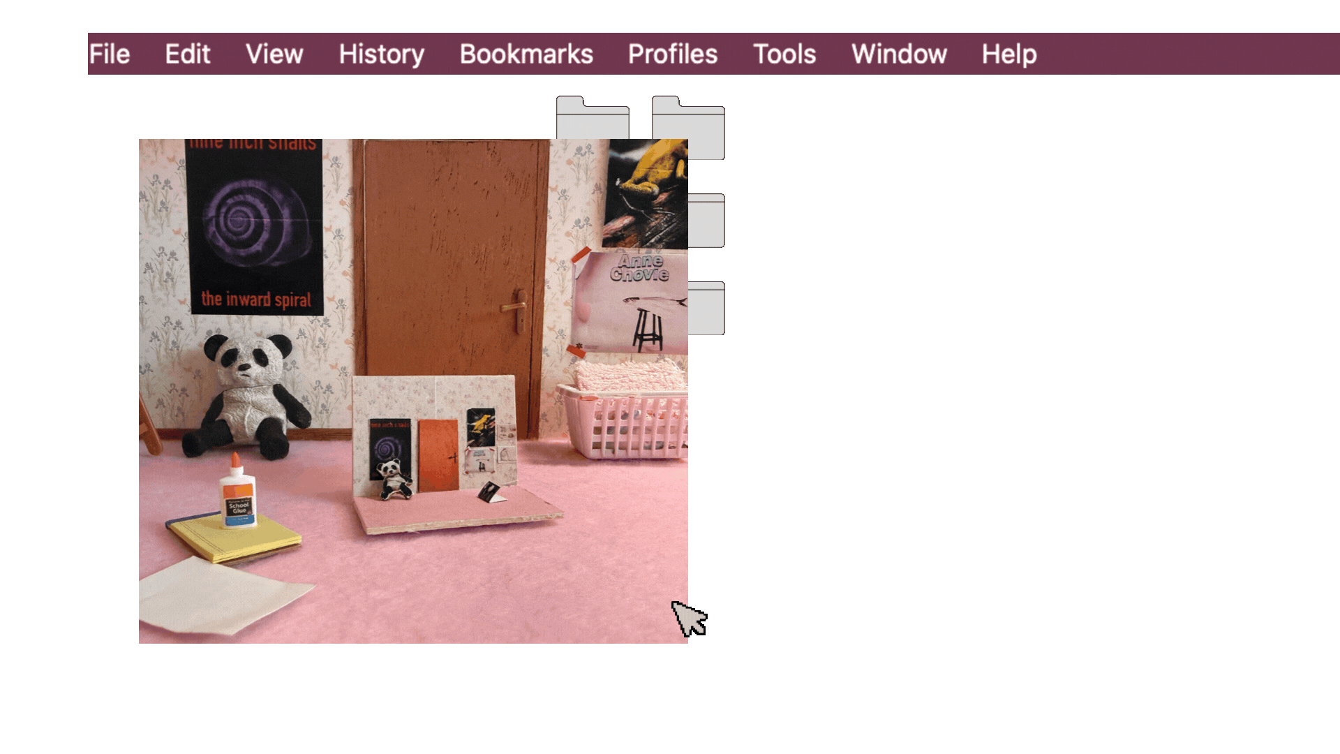 A pink carpeted room decorated with posters, stuffed animals, glue, paper... Velveeta the snail's creative workspace.