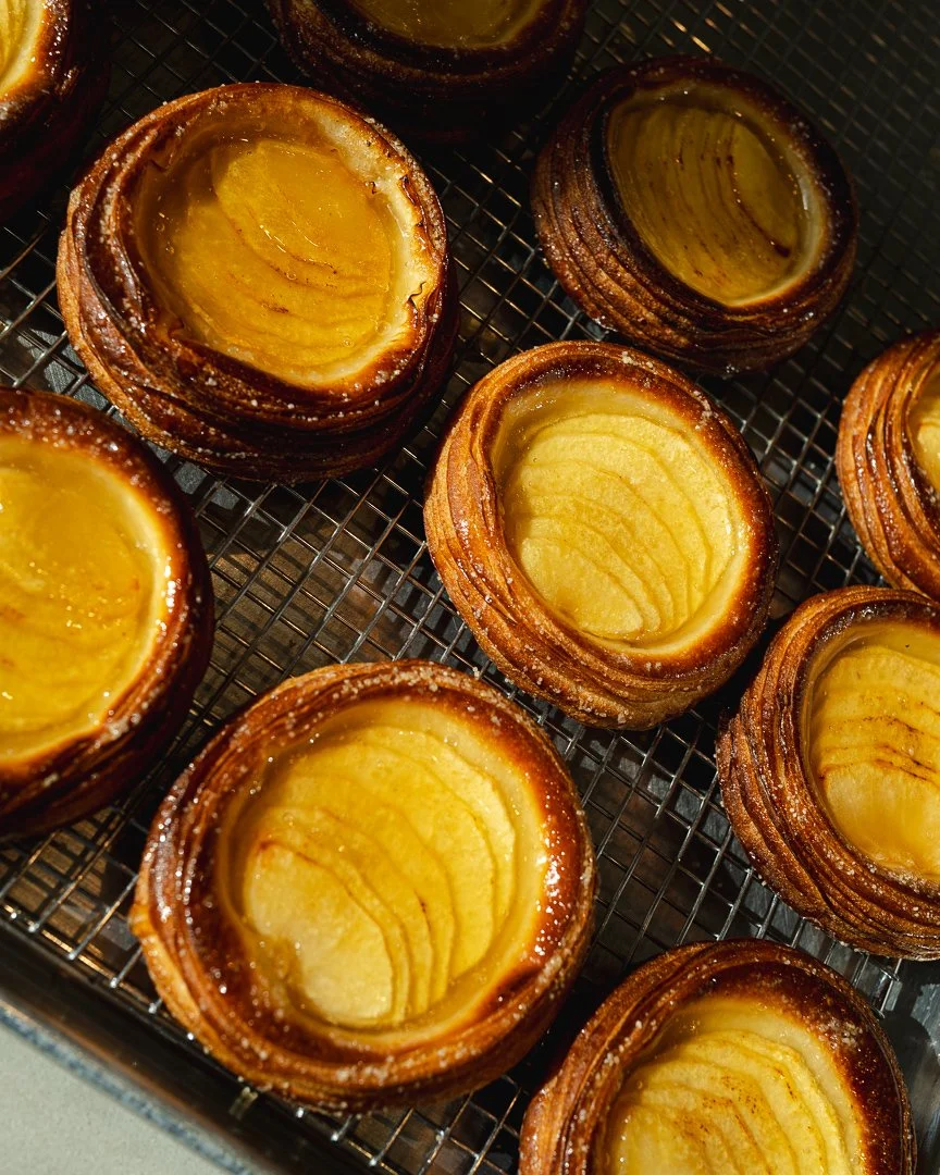 Apple tarts with fanned apple slices cooling on a wire rack, Louma Bakery fall menu
