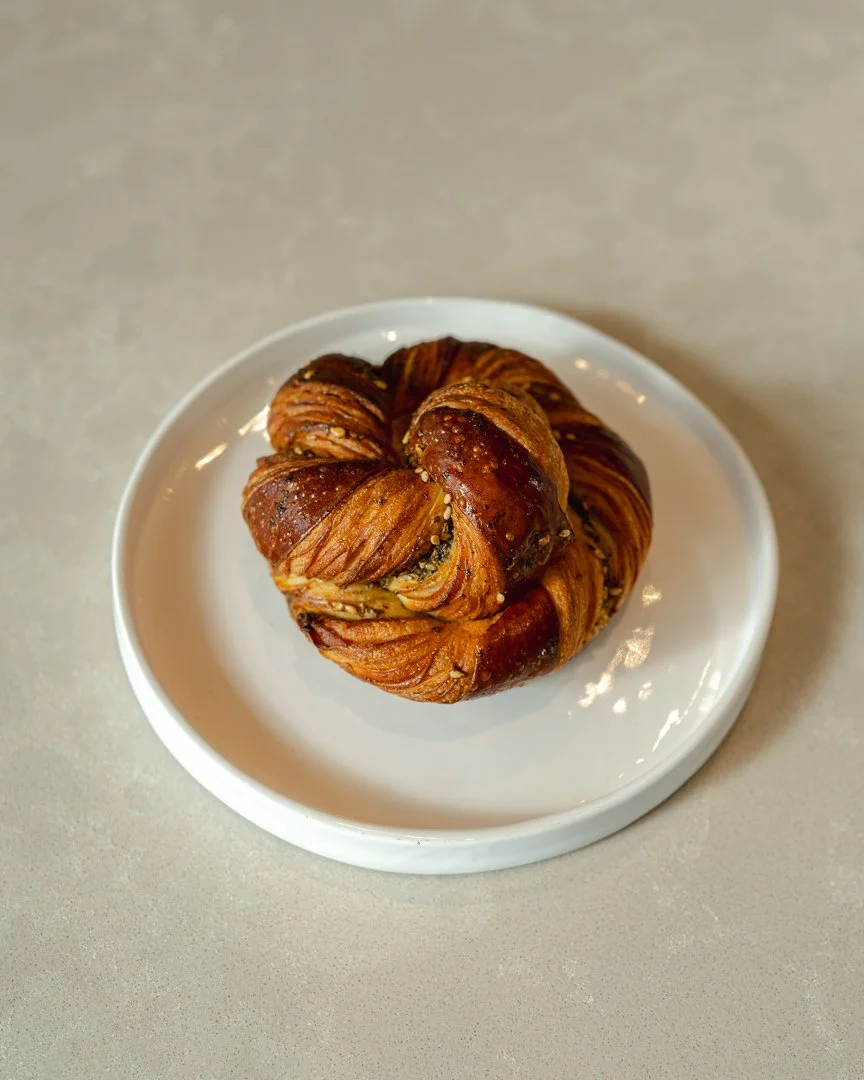 Twisted laminated knot zaatar pastry on a white plate, Louma Bakery Santa Monica