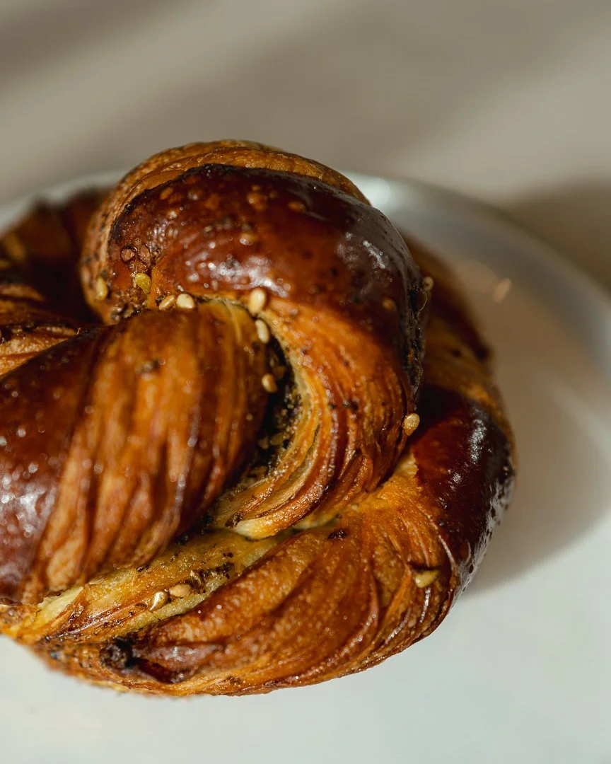 Close-up of a glossy twisted pastry with zaatar, pastry photography