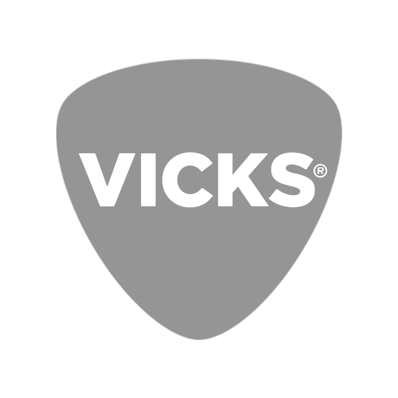 A gray guitar pick with the word VICKS in black bold letters on it.